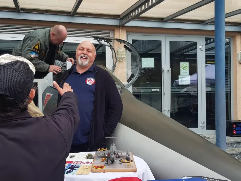 Talk and laughter with the crowd in front of the Starfighter cockpit